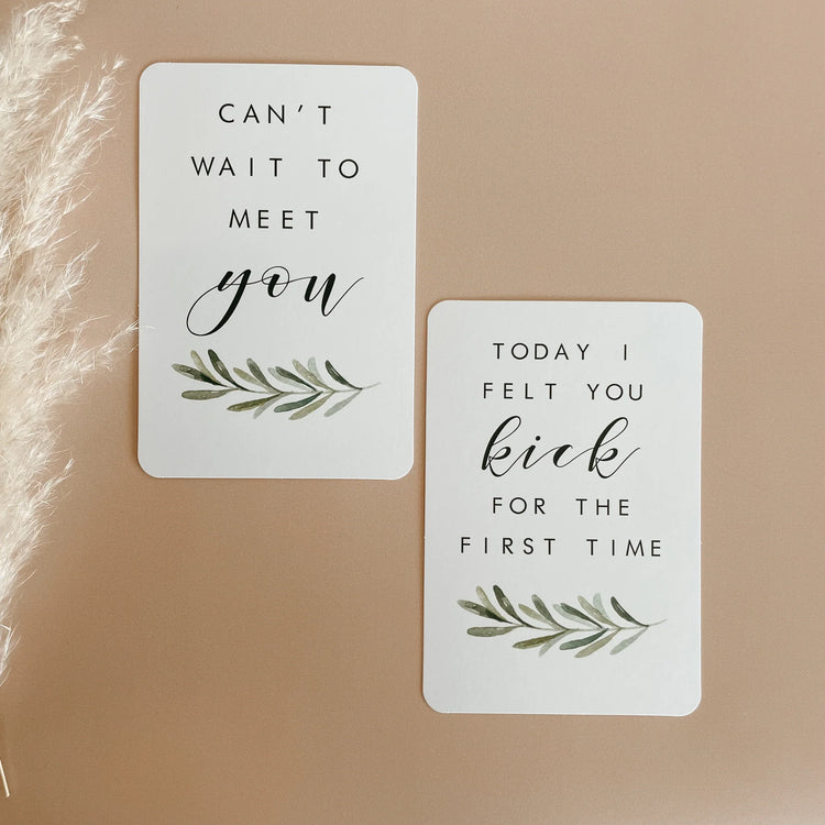 Beige background with two white cards. One says 'Can't wait to meet you' and 'today i felt you kick for the first time'.