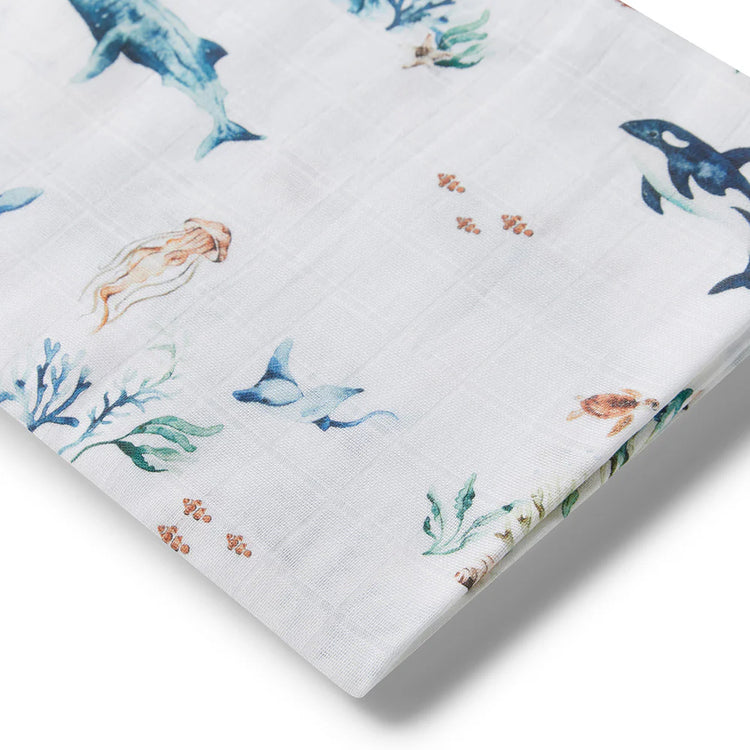 Baby Swaddle with ocean-themed design featuring sharks, octopuses, and corals on a white background.