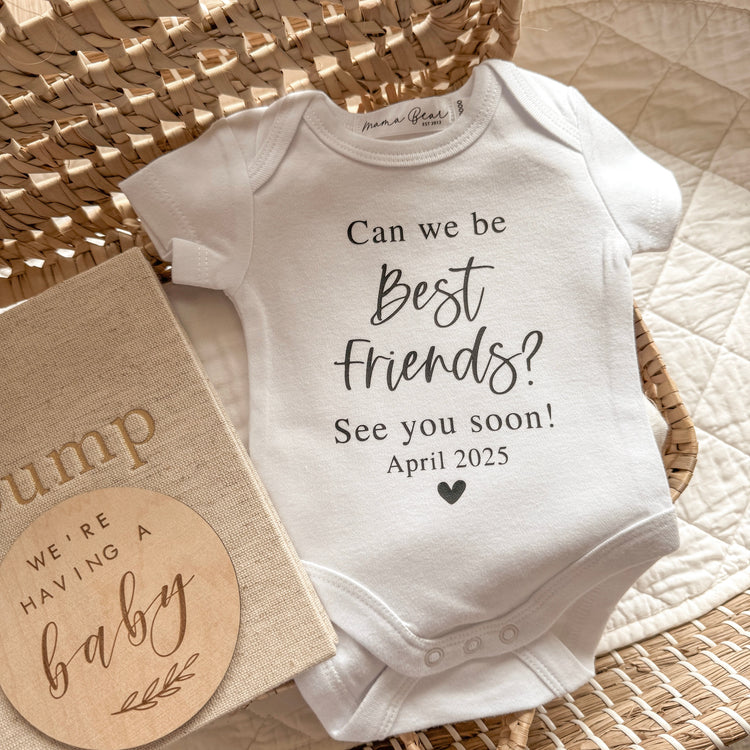 Pregnancy announcement onesie to surprise family and friends with. Onesie has black text saying 'Can we be Best Friends? See you soon! And includes the due date.