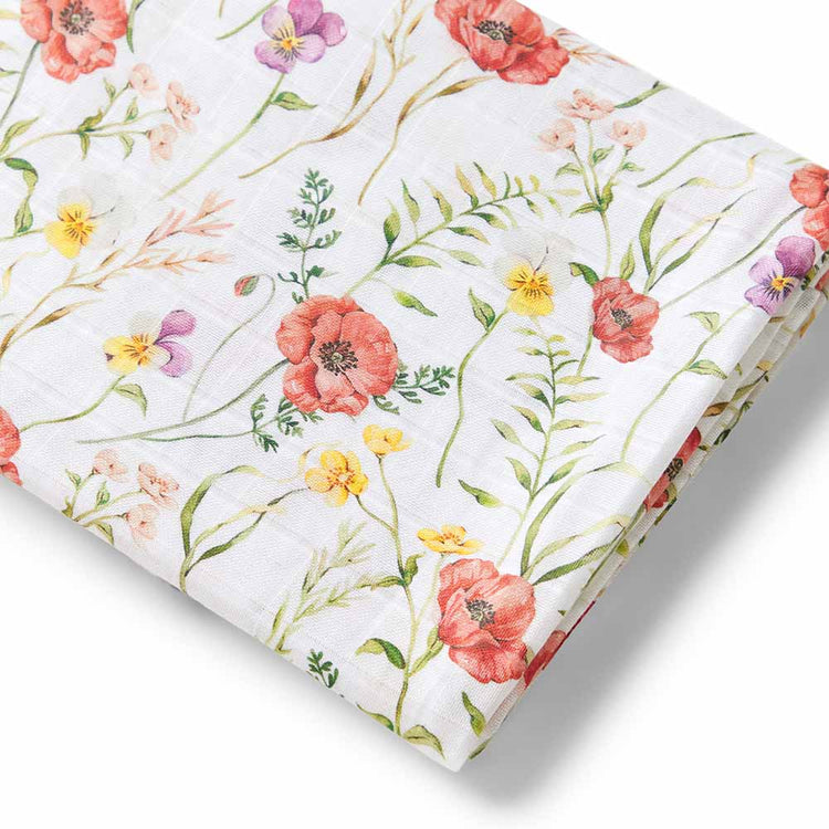 Floral patterned baby muslin wrap with pink, red, yellow, and purple flowers on a white background
