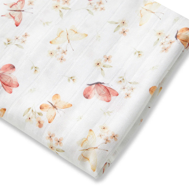 Floral-patterned muslin wrap with pink and orange flowers and butterfly on a white background