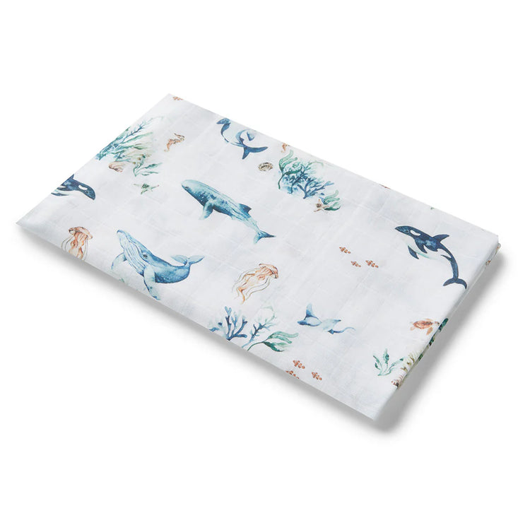 Sea life illustrations on a baby swaddle, seaweed, whales, jelly fish, sea horse.