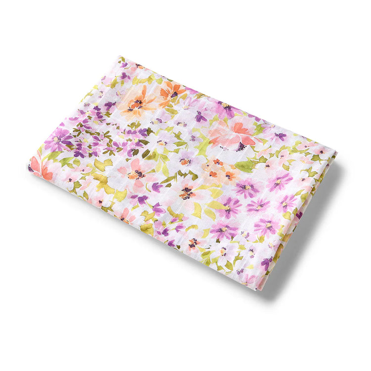 Floral baby swaddle with pink, yellow, and green flowers on a white background