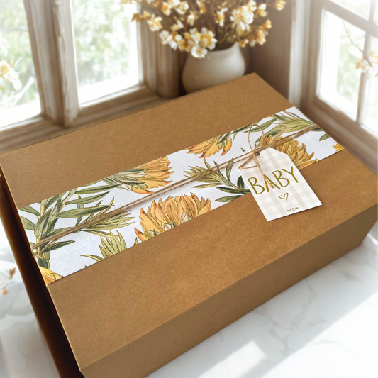 Natural kraft magnetic baby gift box with yellow native floral wrap and “Baby” gift tag — ideal for gender neutral baby gift, pregnancy reveal, or baby shower present.