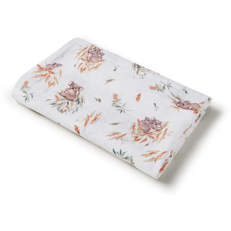 White baby swaddle with illustrations of koala bears and leaves