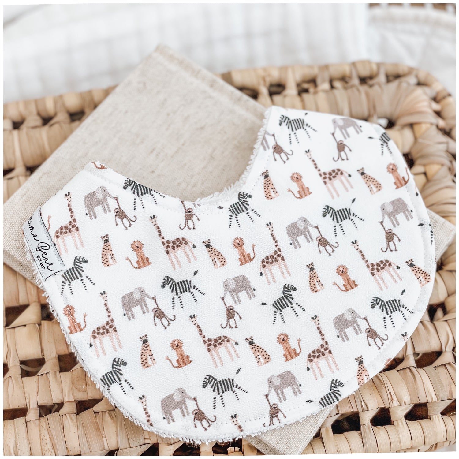 Animal baby bib, gender neutral / unisex. Features mini safari animals, lions, cheetah, elephant, zebra, monkey, giraffe on it.