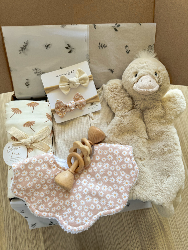 A unique gift hamper featuring gorgeous shades of beige and blush pink makes for a very special newborn baby gift. 