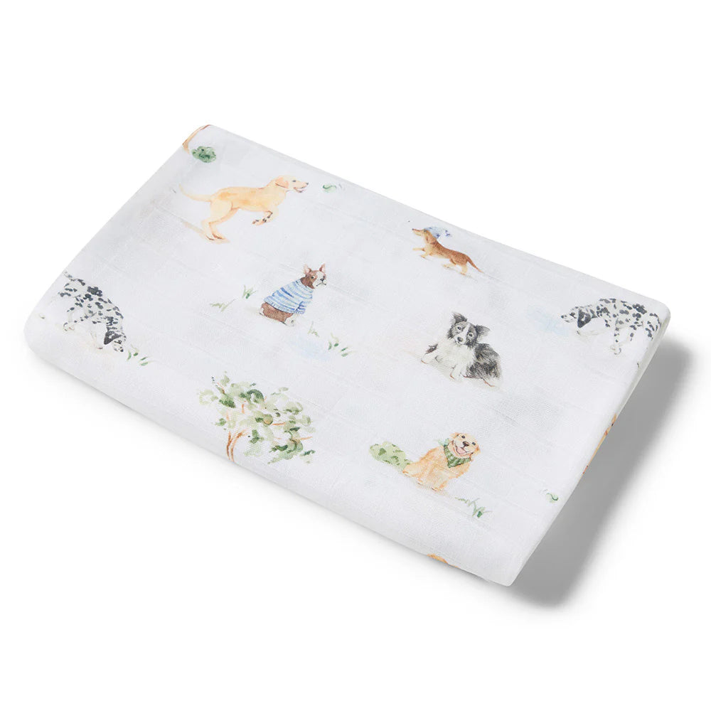 Muslin swaddle with different breeds of puppy dog drawings on it.