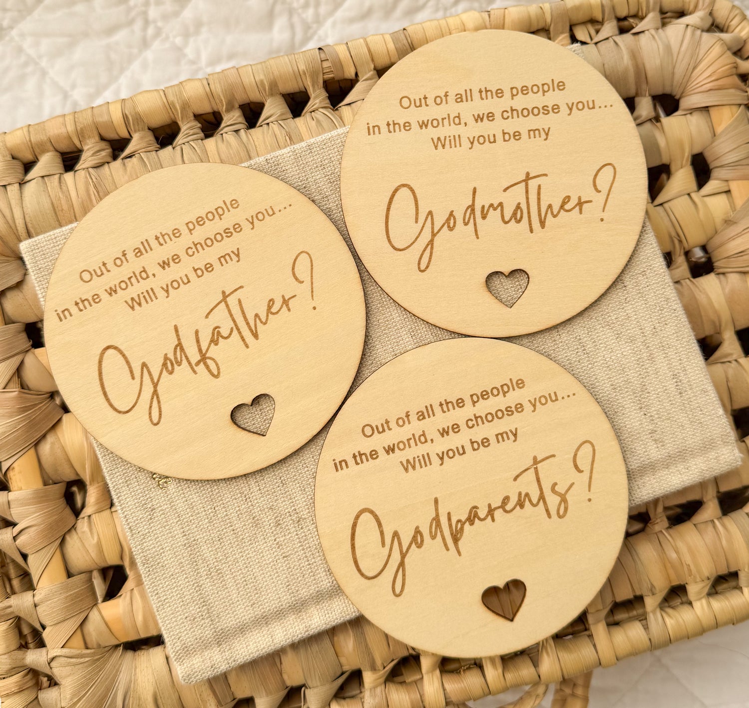 Three wooden tags asking if you will be godparents / Godmother or Godfather on a woven basket background