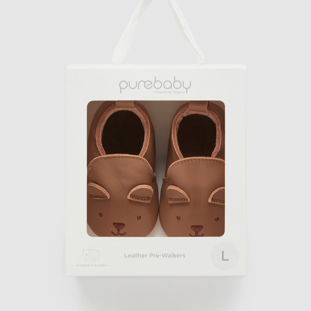Pair of brown baby leather pre-walkers in packaging with 'purebaby' branding on a white background.