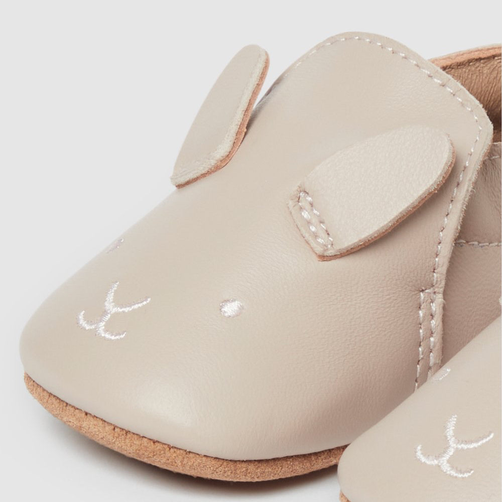 Beige baby shoes with white bunny face.