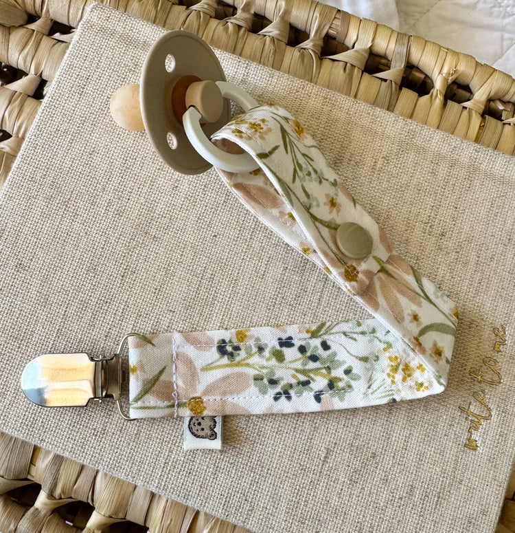 Handmade dummy clip in a pastel pink and green floral tone.