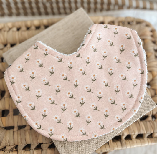 Handmade blush pink baby bib with a dainty daisy floral print; backed with absorbent terry towelling, ideal for newborns, teething, and baby gifts.