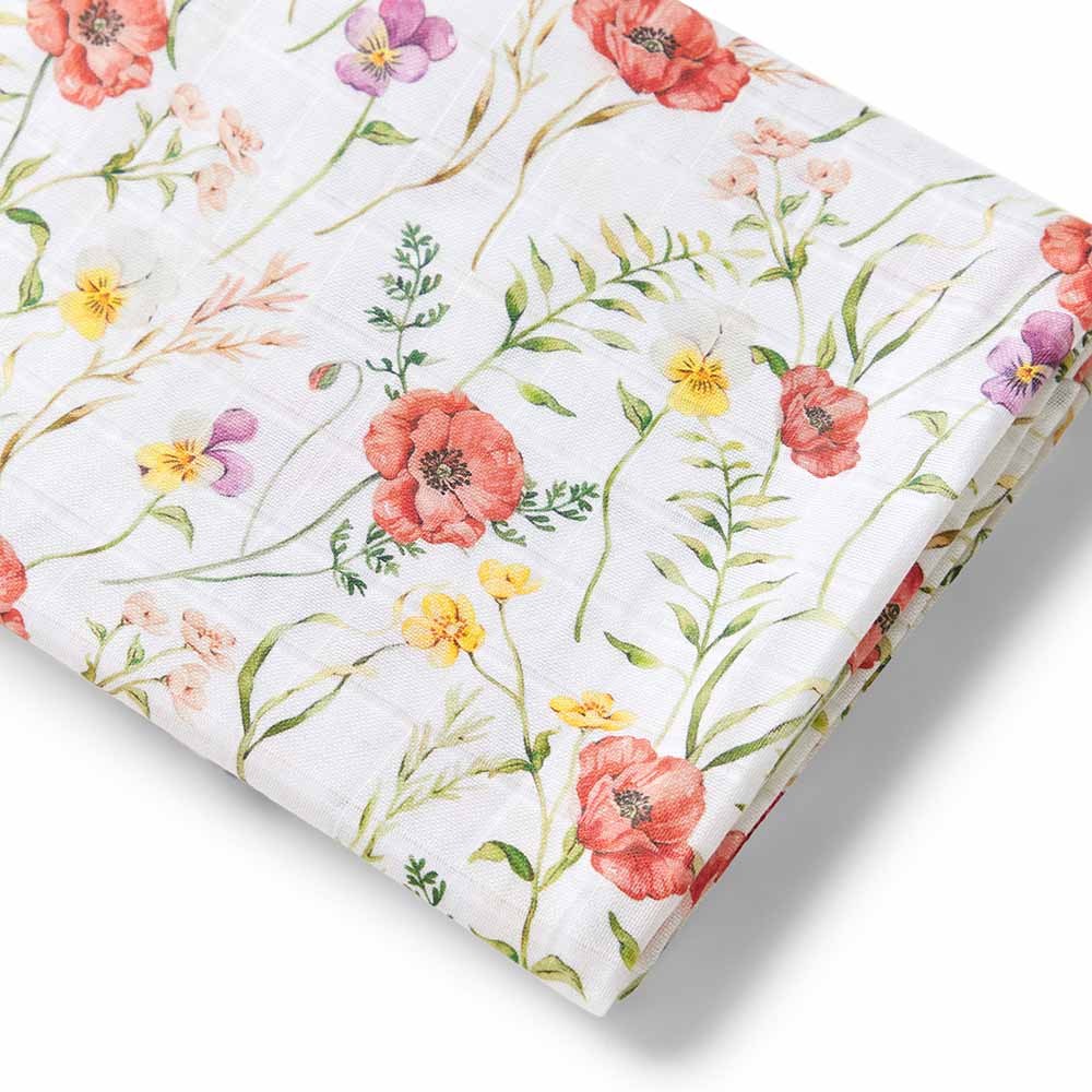 Floral patterned baby muslin wrap with pink, red, yellow, and purple flowers on a white background