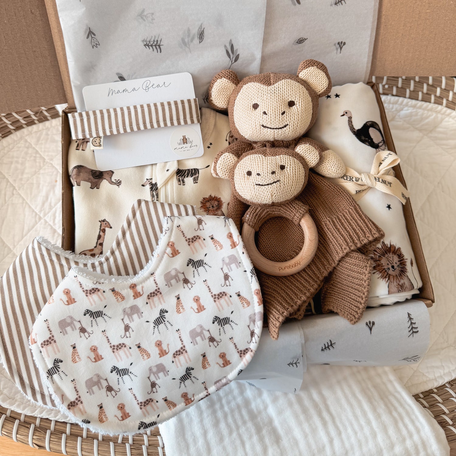 Unisex baby gift hamper featuring a zoo-themed design, including a monkey comforter, matching wooden rattle, animal-print bib, and safari-inspired baby essentials. Perfect for newborns, baby showers, or baby boy gifts with jungle and safari themes.