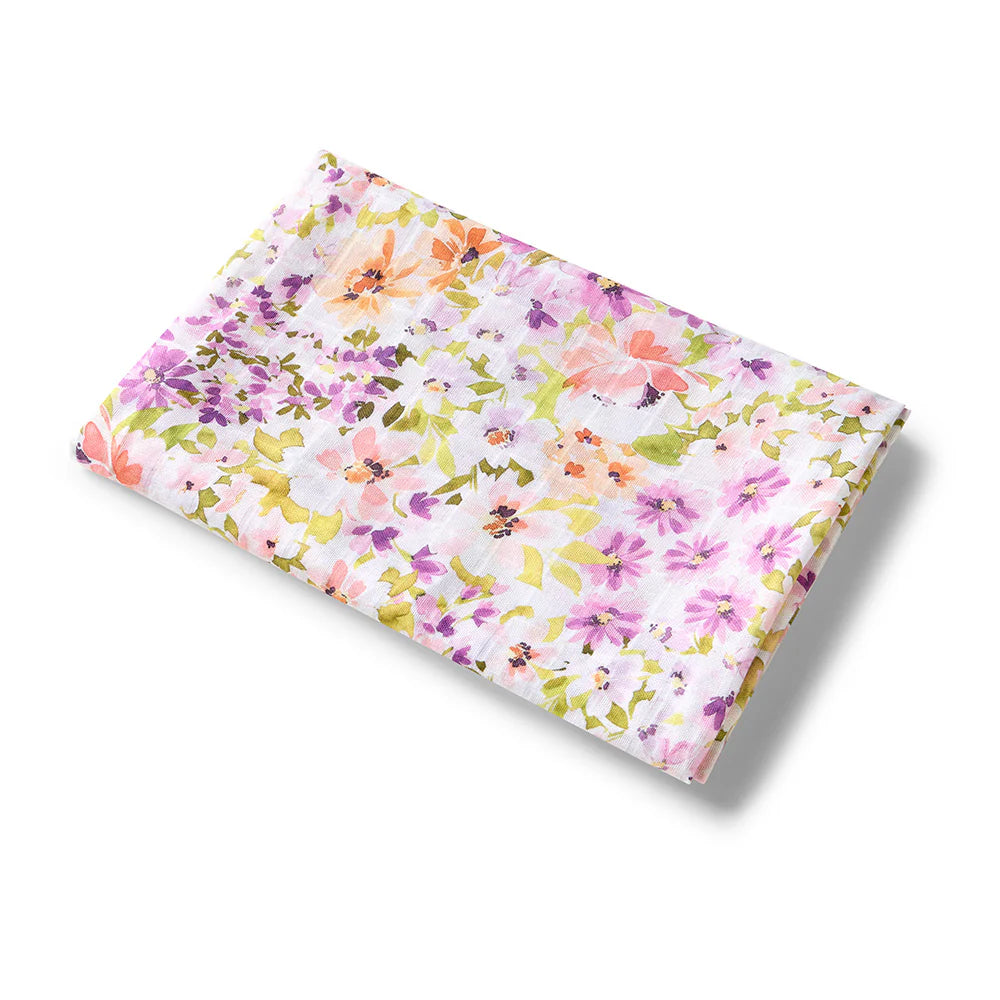 Floral baby swaddle with pink, yellow, and green flowers on a white background