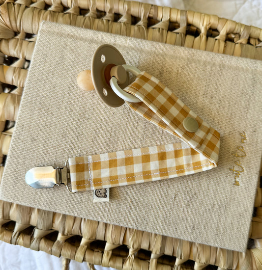 Handmade vibrant mustard and cream gingham check dummy clip with metal clasp.