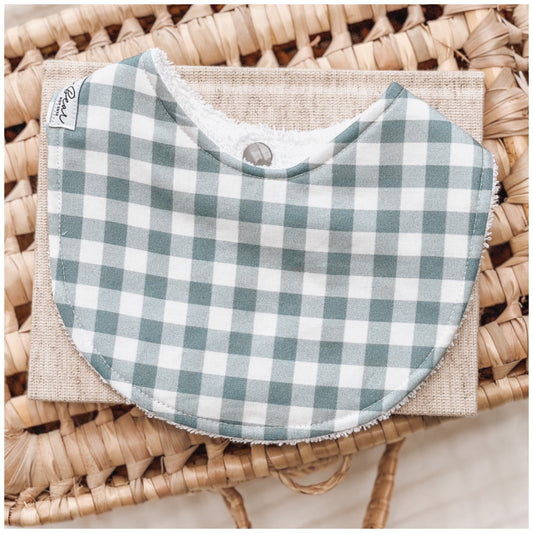 A soft blue and white gingham baby bib—perfect for a classic look that suits baby boys or gender-neutral gifting. Handmade in Australia and backed with absorbent terry towelling to catch dribble, milk spills, and teething mess.

Alt text:
Baby bib with a soft blue and white gingham pattern, photographed on a woven basket with a natural linen cloth underneath.