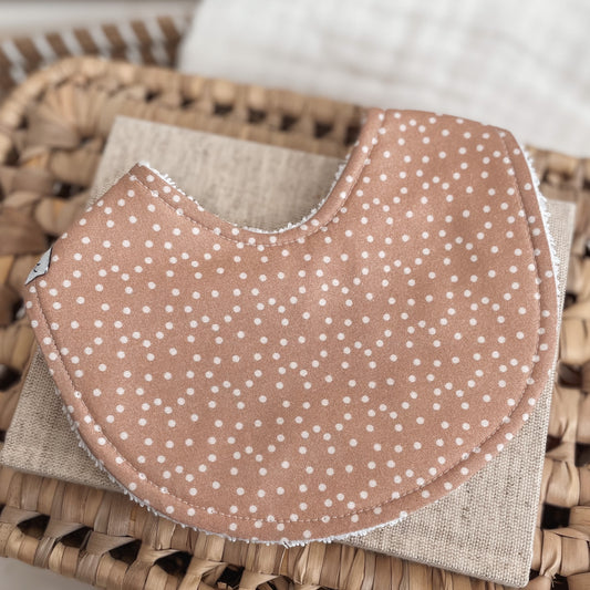 Toffee brown baby bib with scattered white polka dots and terry towelling backing. Ideal for dribble, feeding, and teething in a gender-neutral style.